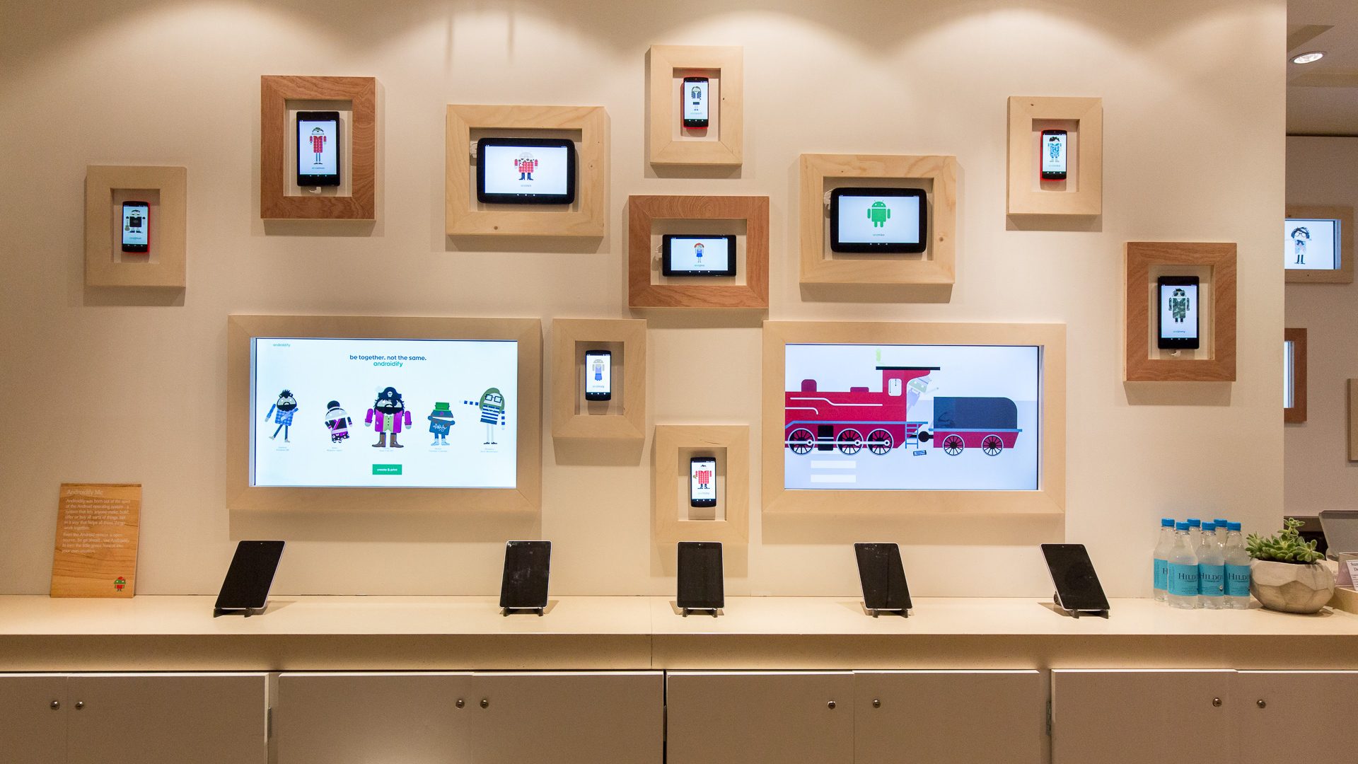A wall of framed tablets each showing a freshly created Android avatar