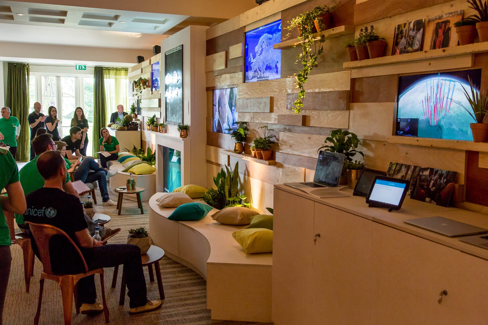 The timber-clad UNICEF lounge at Google Zeitgeist with the installation tablet on the counter